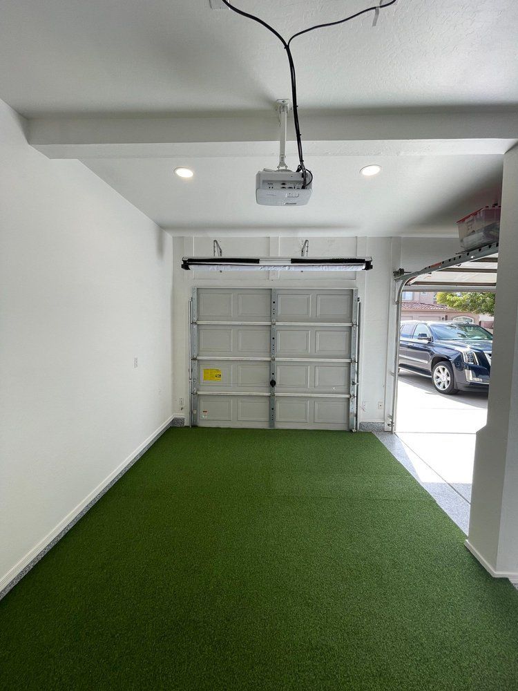 A garage with a car parked in it and a projector on the ceiling.