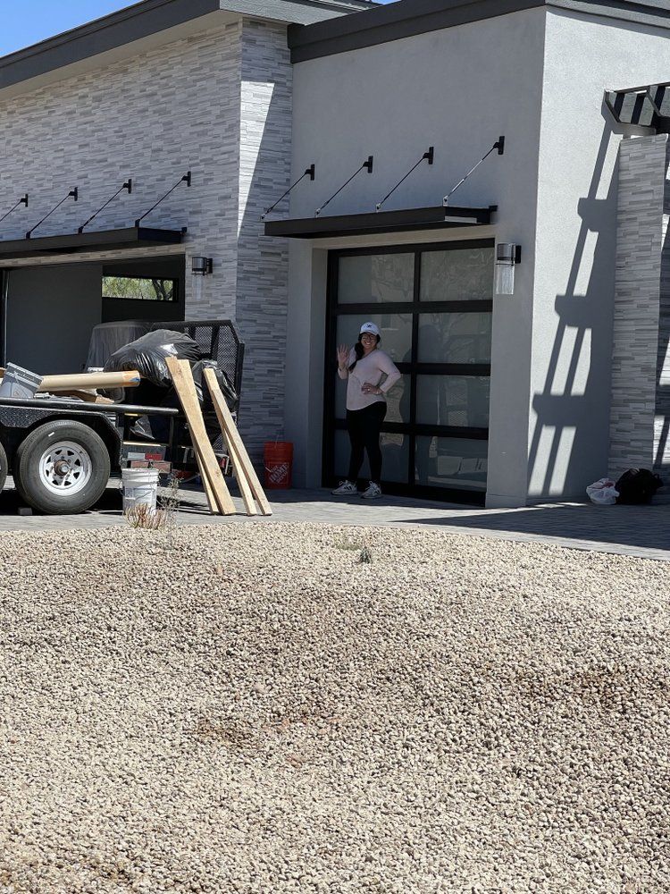 A woman is standing in front of a house under construction.