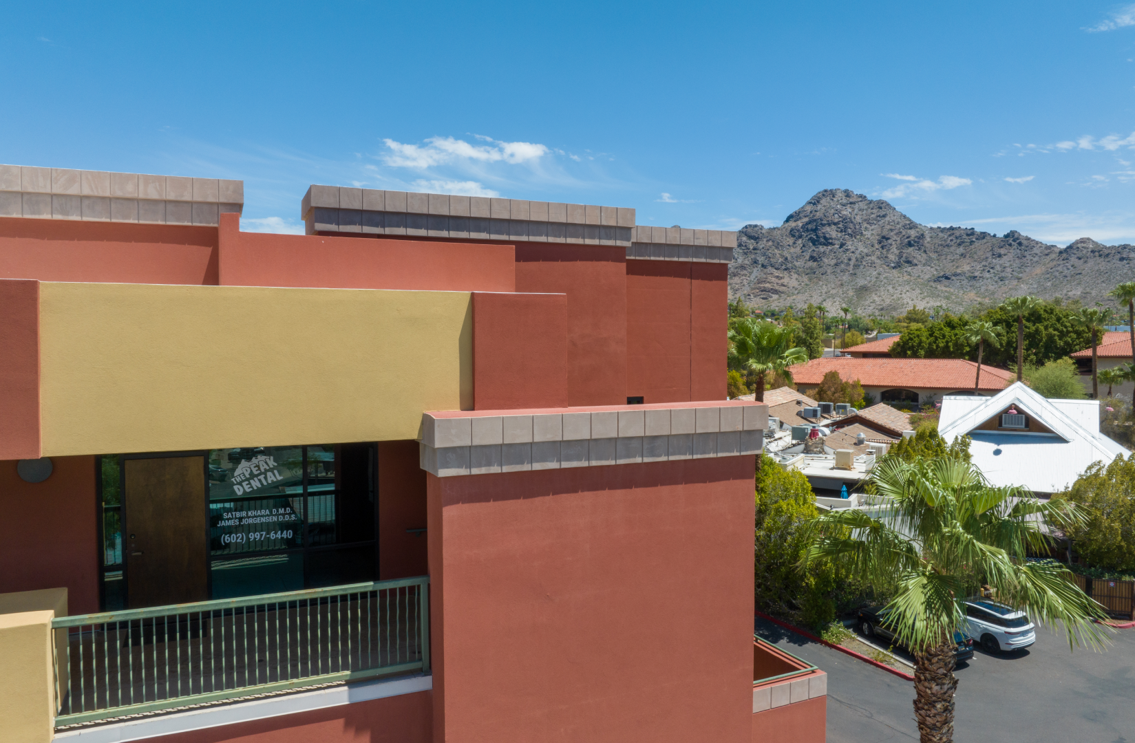 An aerial view of a building with a mountain in the background