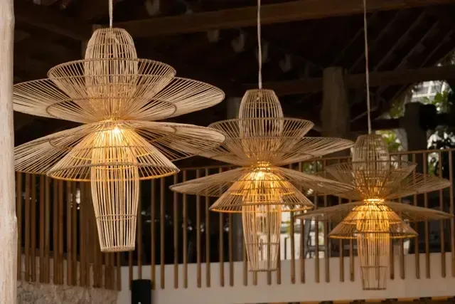Lámparas artesanales de fibra en Hotel Aimarawa en San Antero, con luz cálida y baranda de madera.