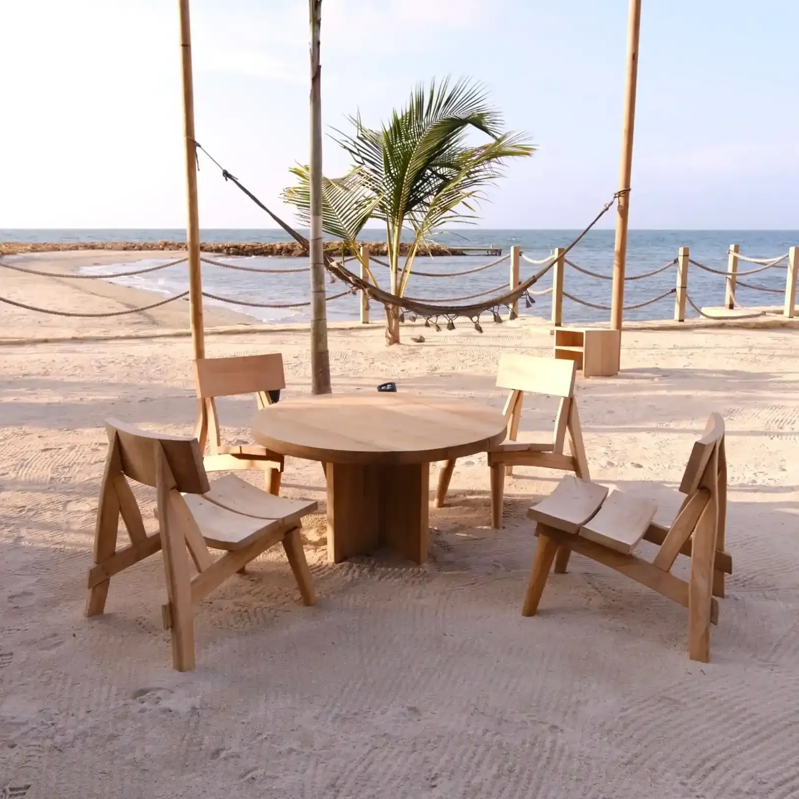 Table and chairs on the sand, hammock, and ocean view at Hotel Aimarawa San Antero.