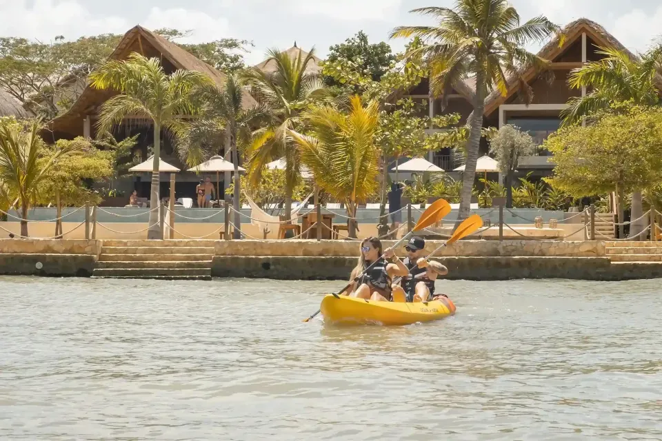 Things to do in San Antero, including kayaking in front of Hotel Aimarawa surrounded by palm trees.