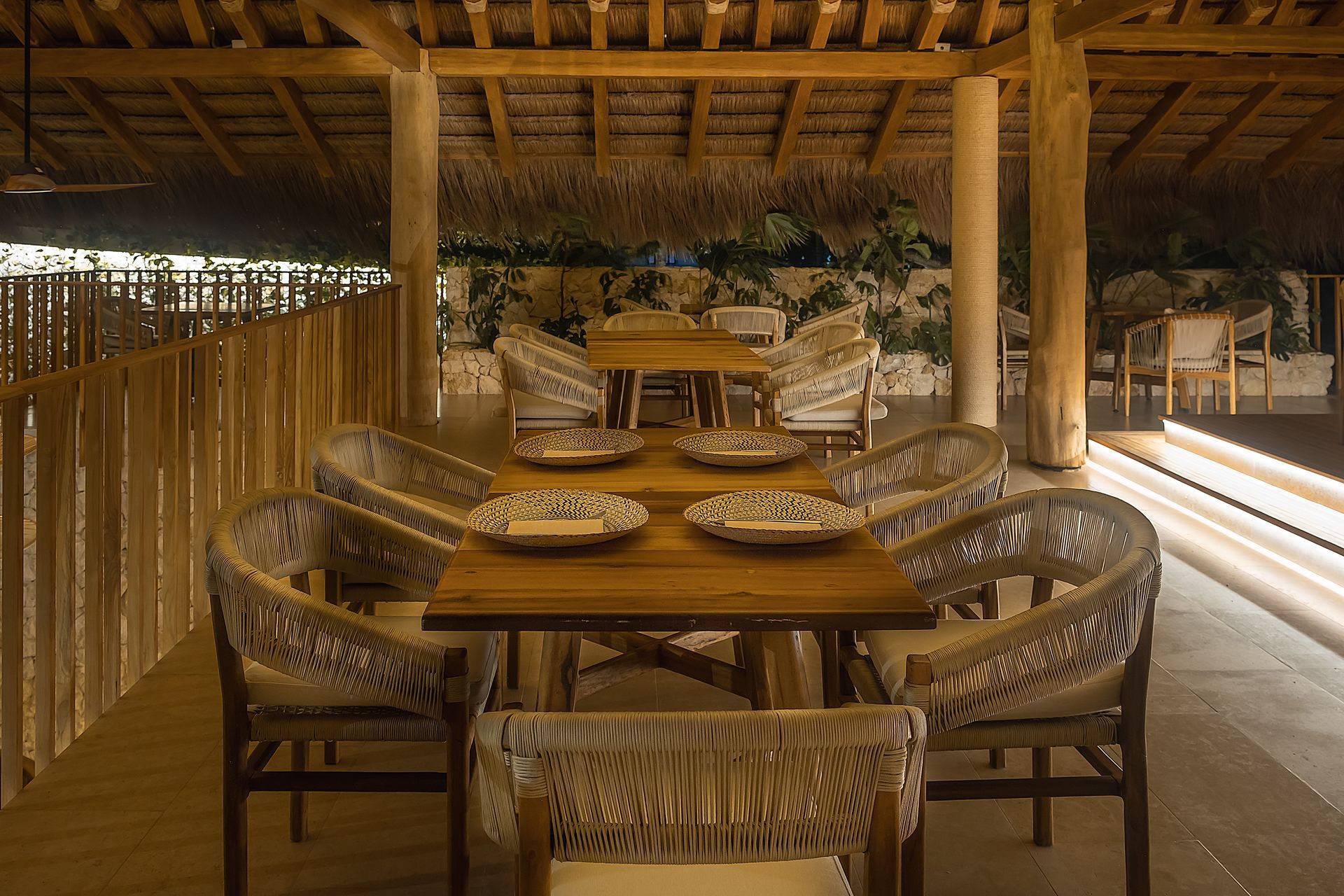 Restaurant in San Antero at Hotel Aimarawa with wooden tables, handmade chairs, and a thatched roof.