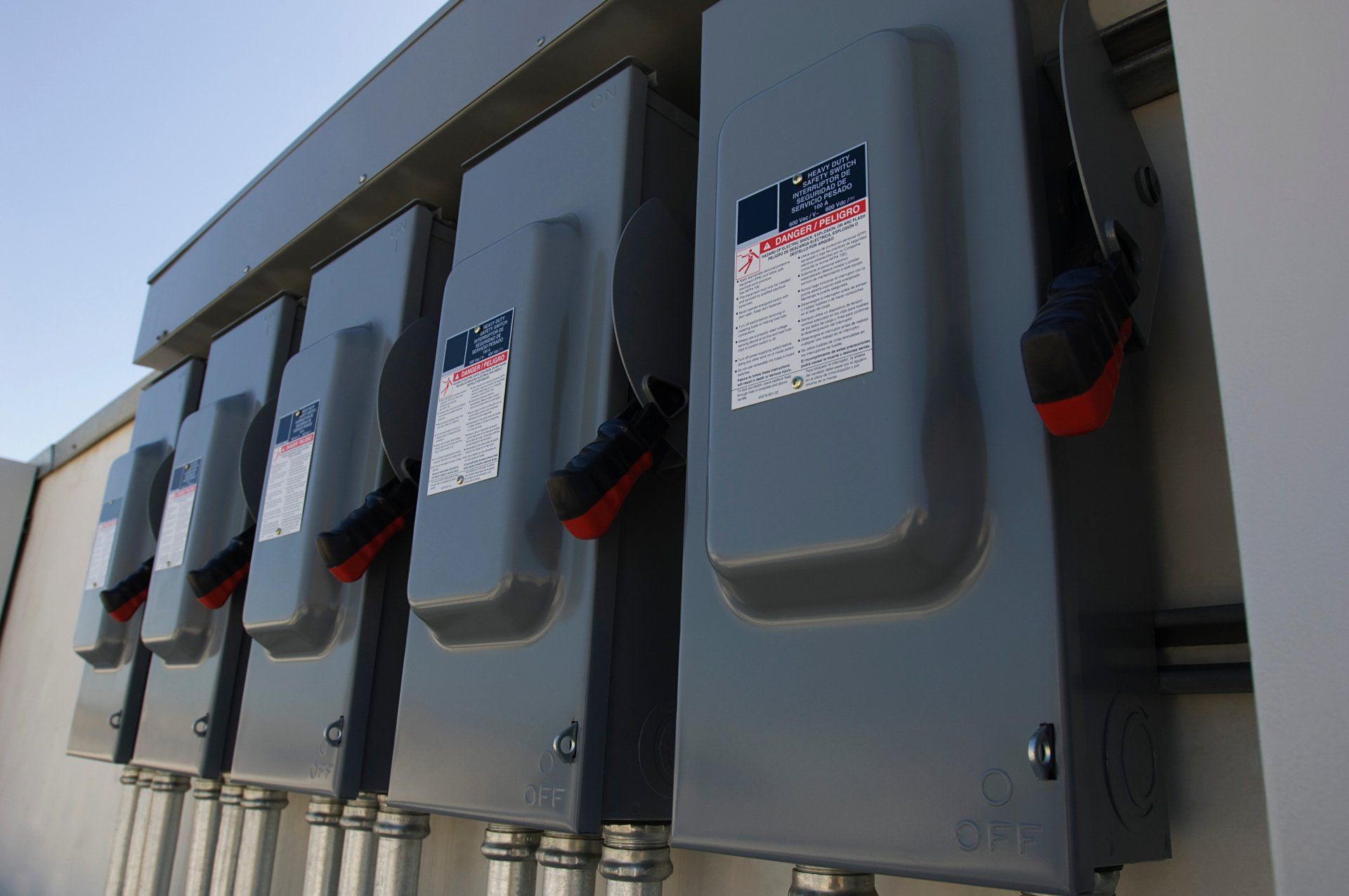 A row of electrical boxes on the side of a building