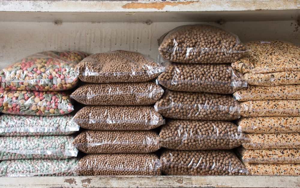 Bags of Pet Food Stacked on Shelves, Varying Shapes — North Coast Stock Feeds in Ballina, NSW
