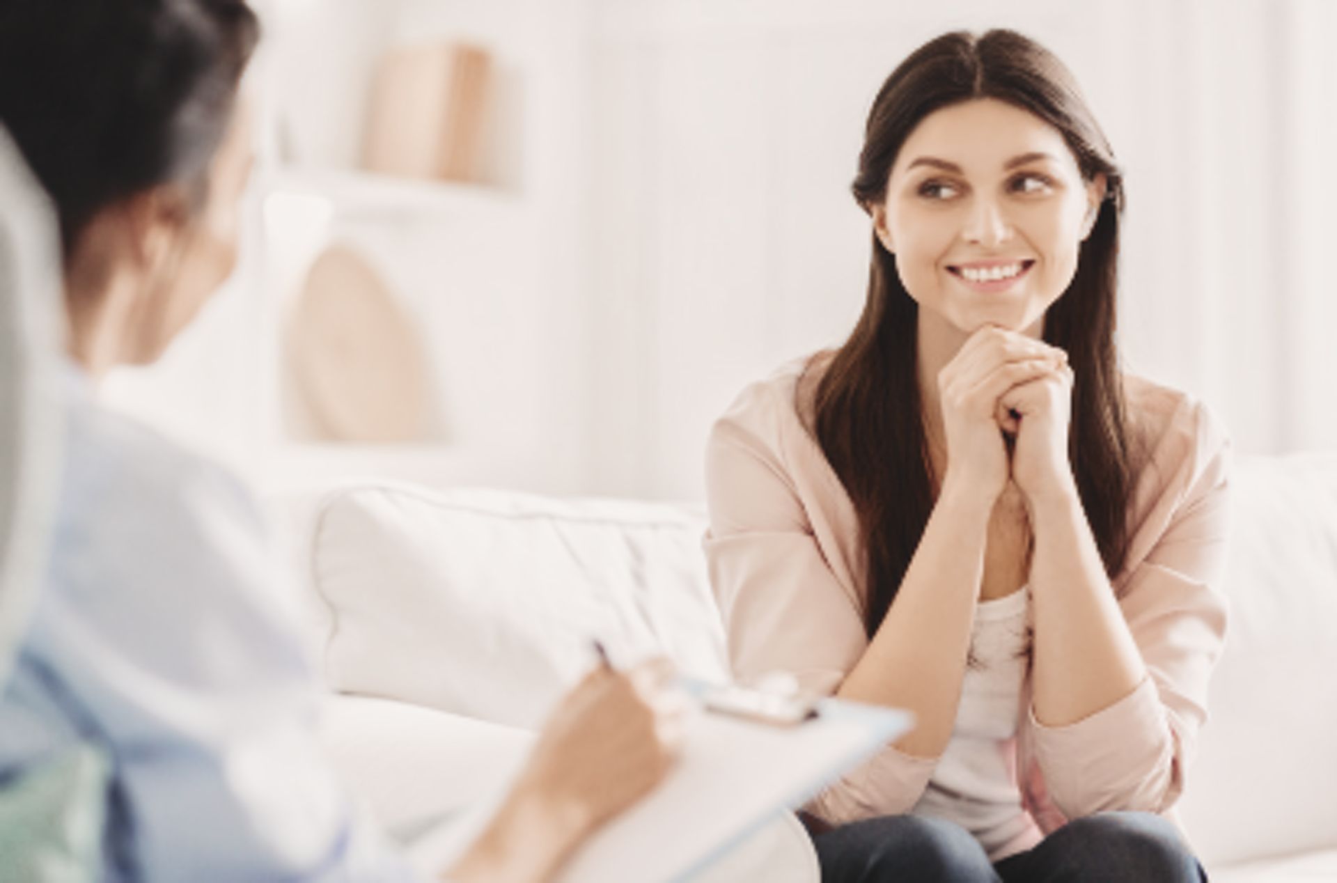 Two women in a thoughtful professional wellness conversation