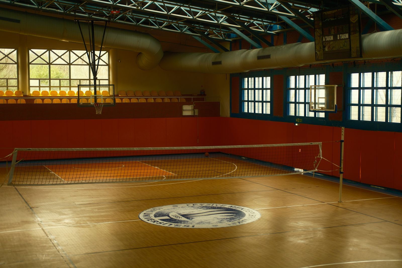 Empty indoor volleyball court and net.