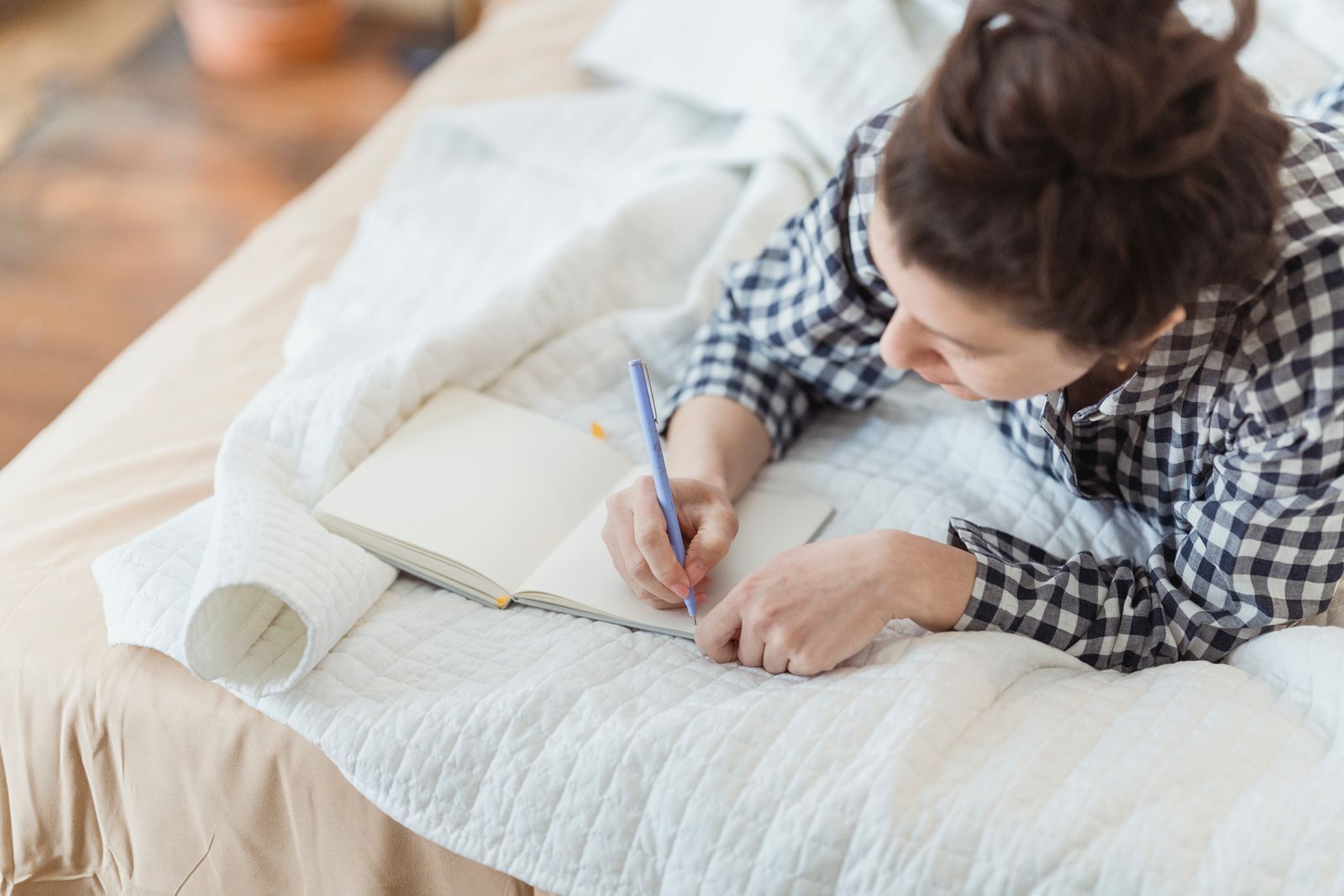 Woman reflecting and writing in her journal.