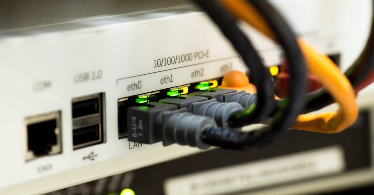 A close up of a router with a bunch of wires plugged into it.
