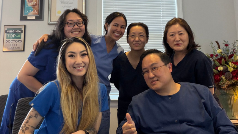 Dr. Cho's Team  posing for a picture in a room.
