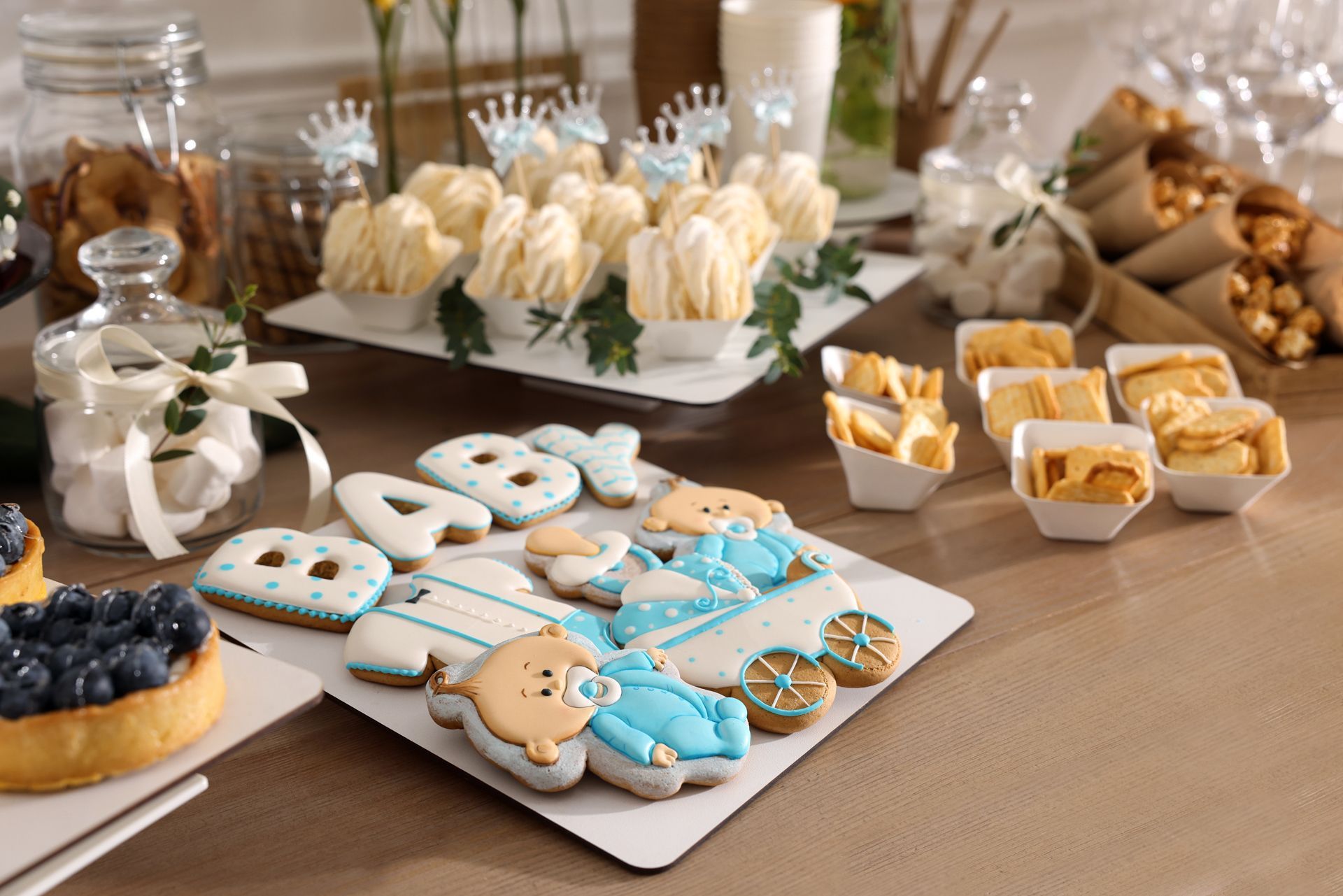 Assorted decorated pastries and cookies displayed on trays on a table