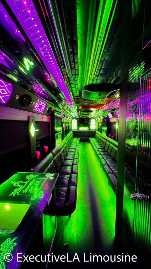 Neon green and purple limousine interior with LED-lit benches and mirrored ceiling