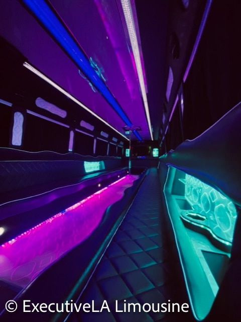 Futuristic limo interior with neon purple and blue lighting and quilted seats