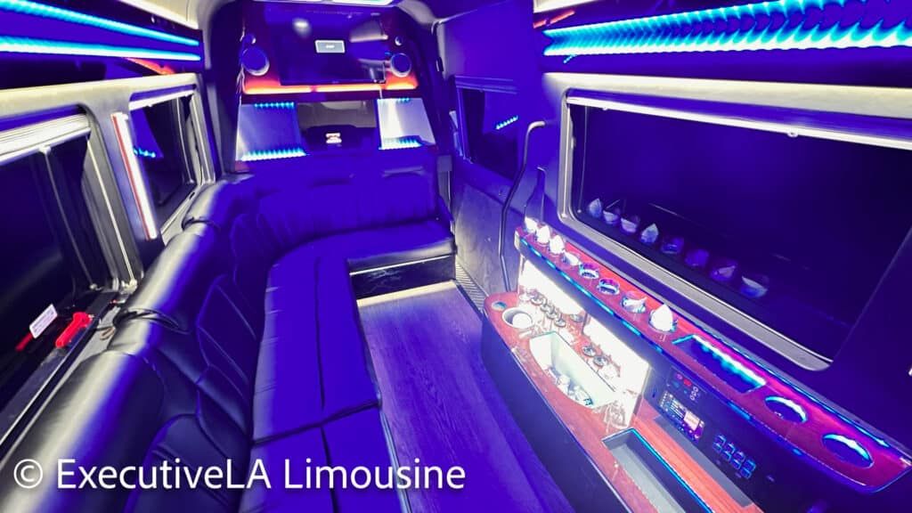 Empty neon-lit limousine interior with purple seating and blue LED accent lights