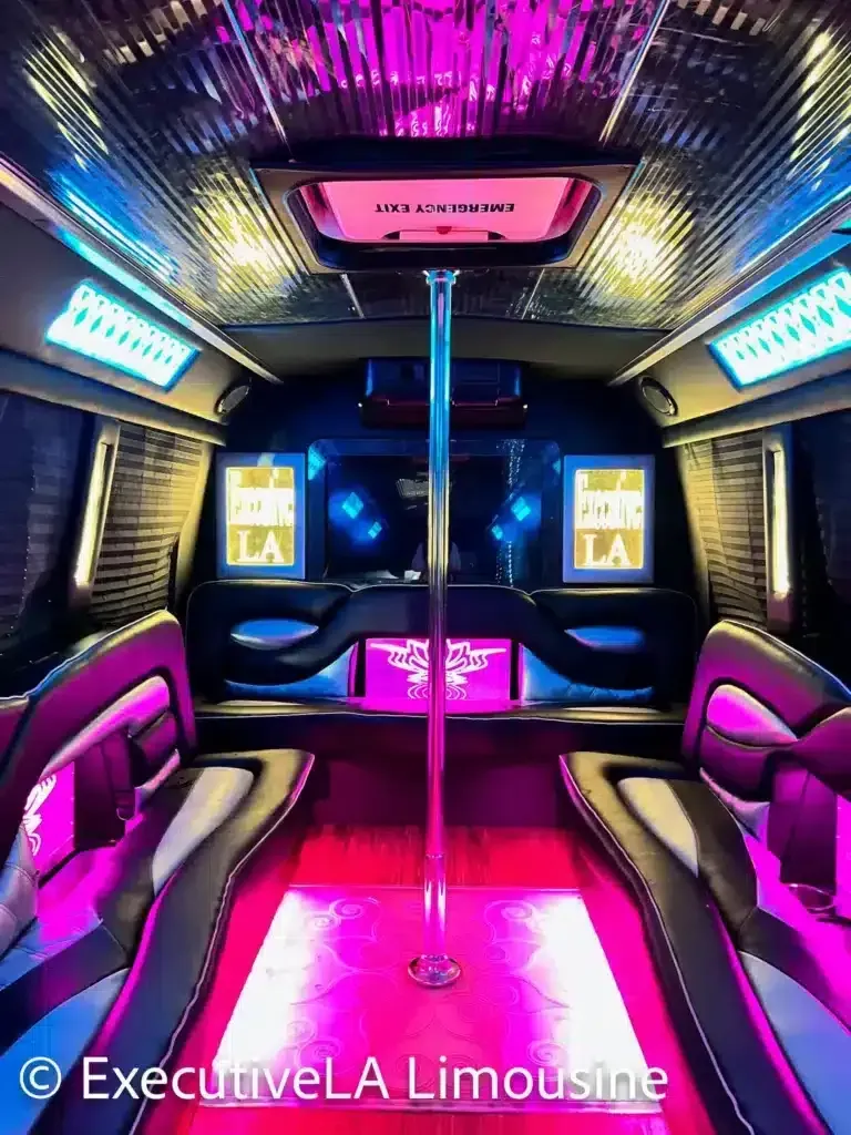 Luxurious limousine interior with neon pink and blue lighting, mirrored ceiling, and plush seating