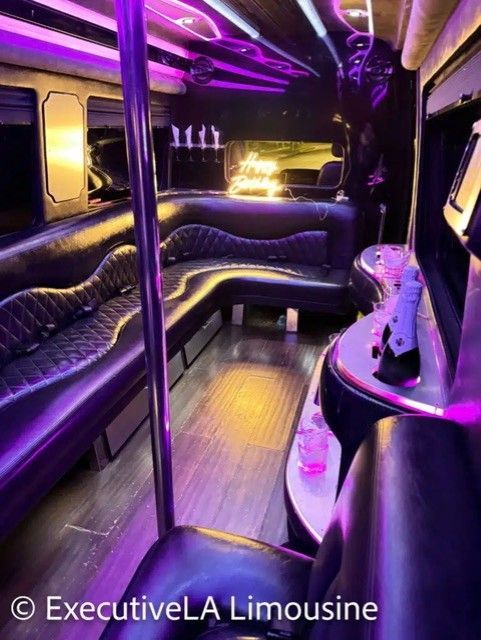 Purple-lit luxury limousine interior with black leather seating and a central aisle