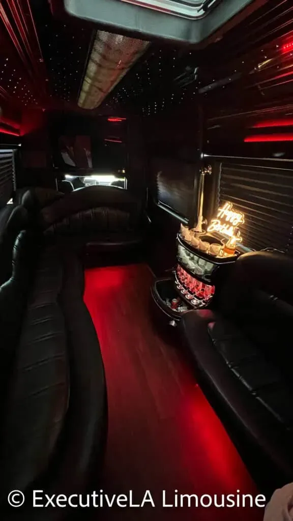 Luxurious limousine interior with red LED lighting and a glowing decorative display on the side table