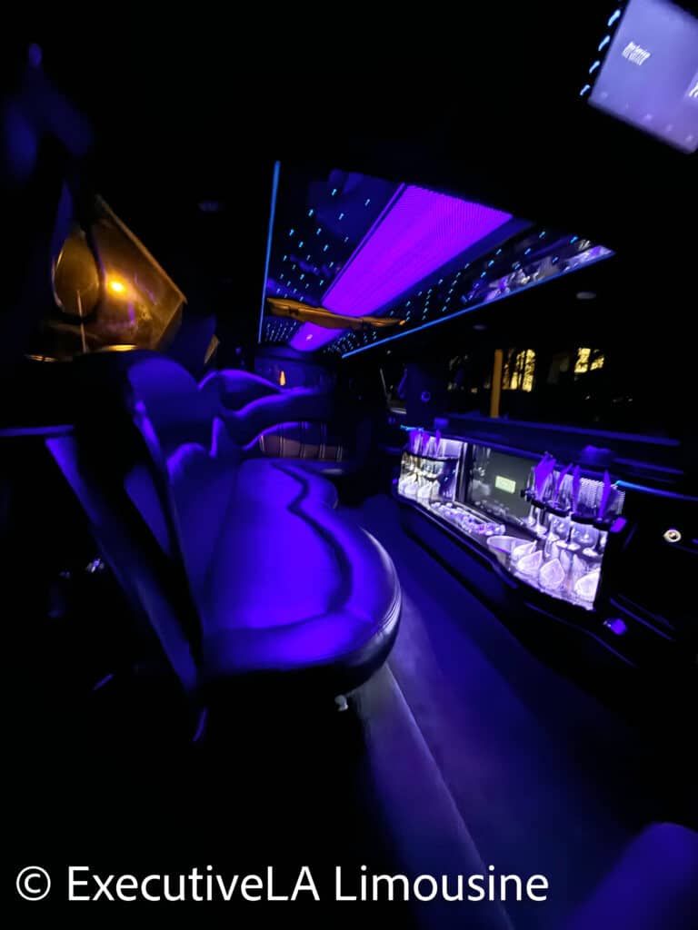 Luxury limousine interior with purple LED lighting and leather seats