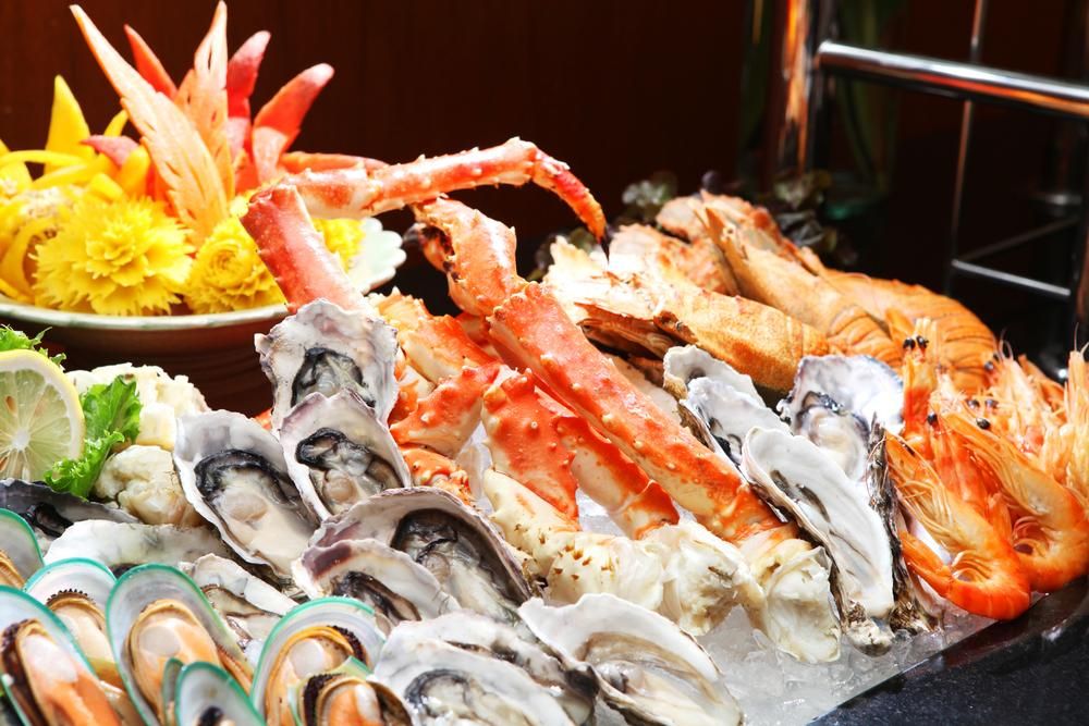 A Variety of Seafood Is Displayed on Ice on A Table — Stones Oysters & Shed Takeaway in Harrington, NSW