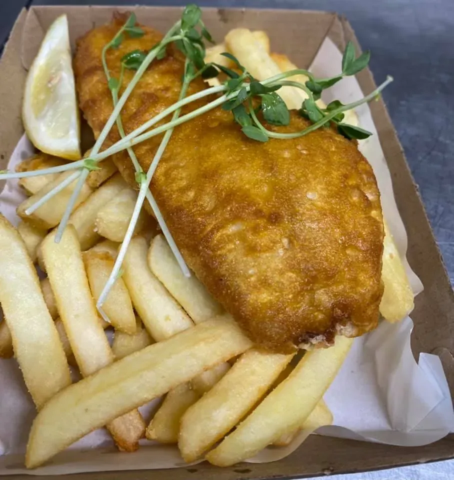 A Box of Fish and Chips With a Slice of Lemon on Top — Stones Oysters & Shed Takeaway in Taree, NSW