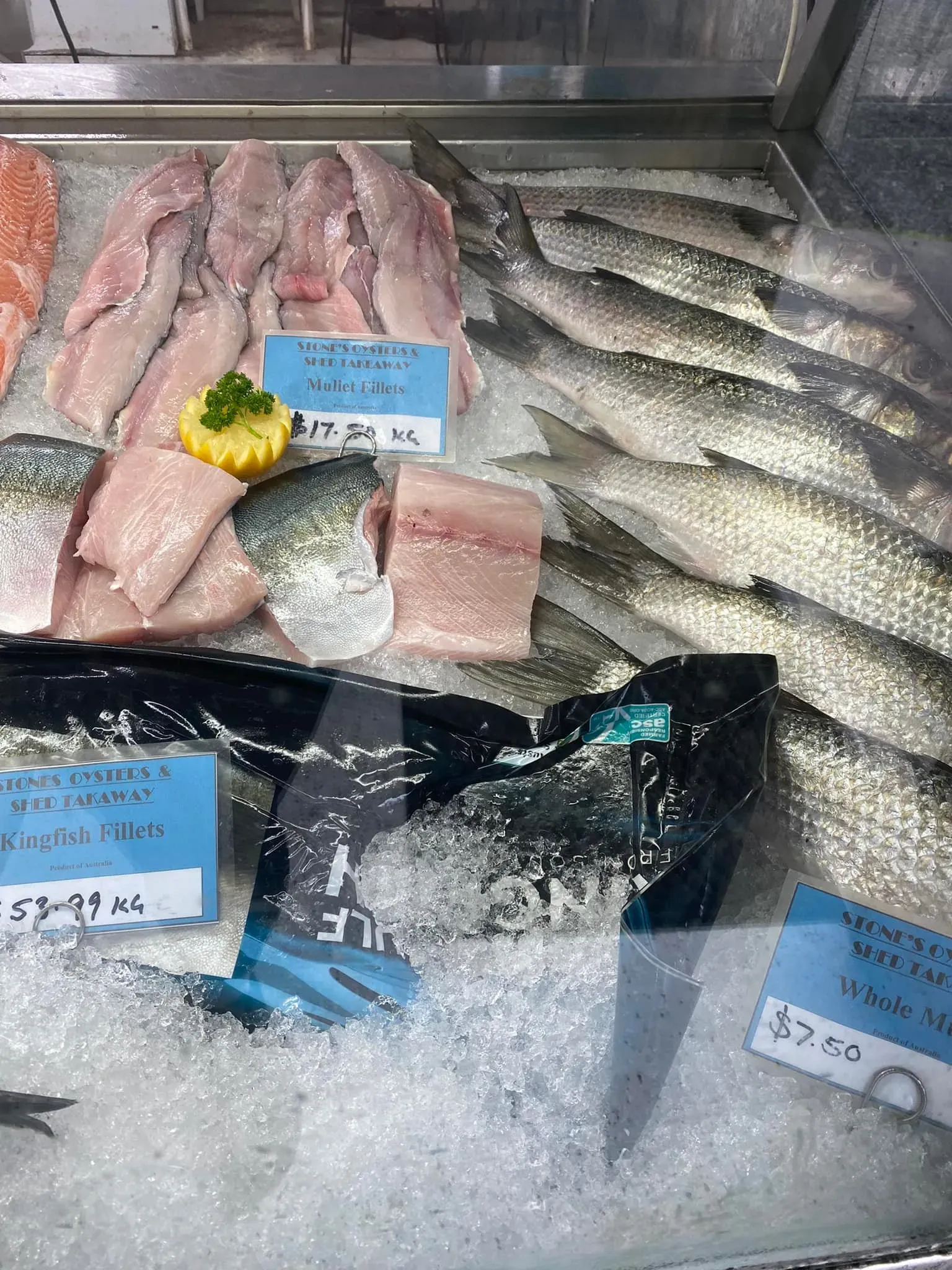 A Variety of Fish Are Displayed on Ice at a Fish Market — Stones Oysters & Shed Takeaway in Taree, NSW