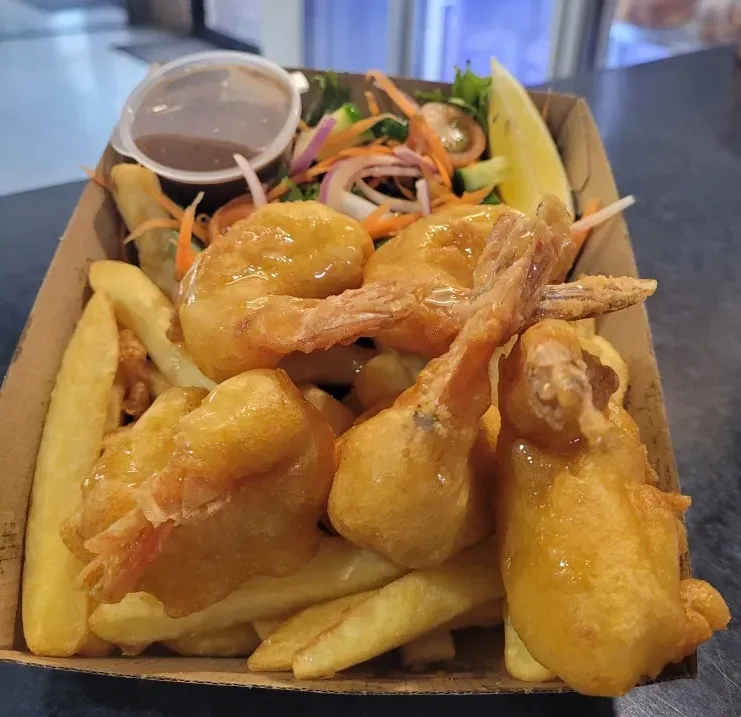 A Cardboard Box Filled With Fried Shrimp and French Fries — Stones Oysters & Shed Takeaway in Taree, NSW