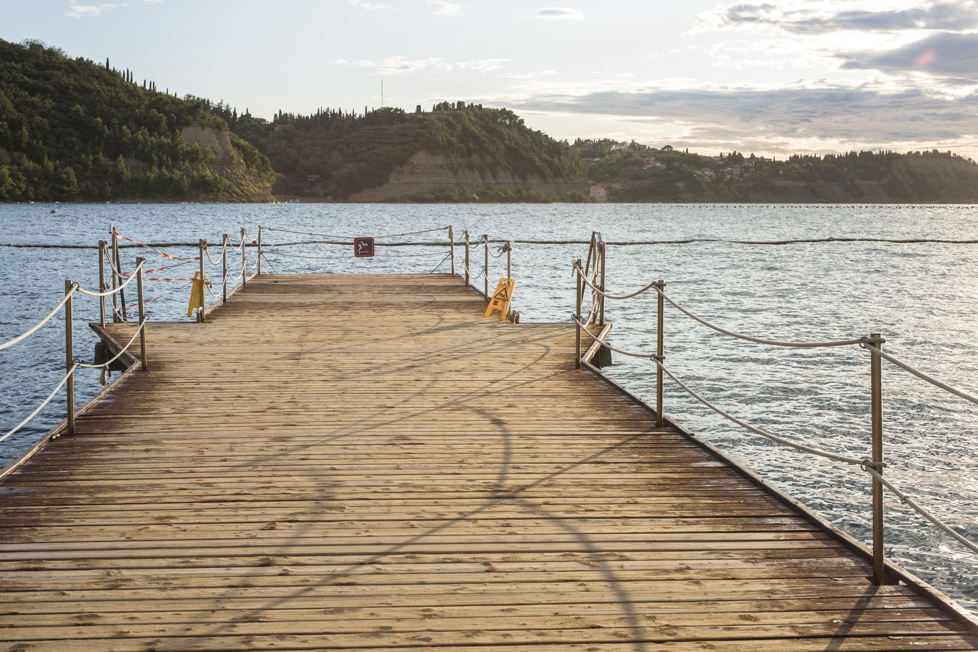 A Wooden Pier Leading into a Large Body of Water — Stones Oysters & Shed Takeaway in Taree, NSW