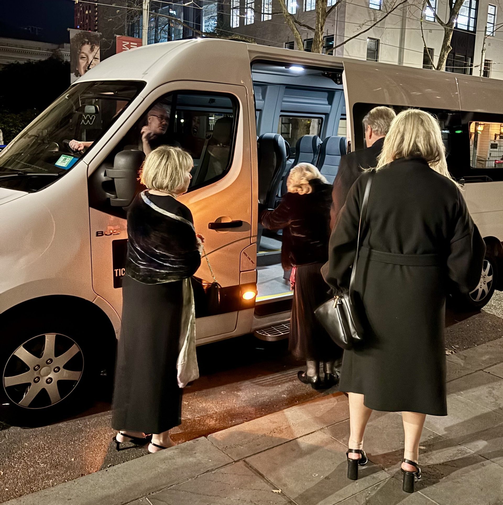 A group of travellers boarding the Ticket 2 Ride minibus after a city function.