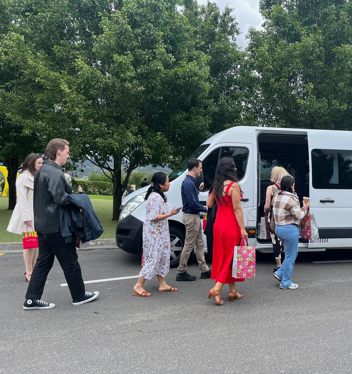 A group of people boarding the Ticket 2 Ride minibus.