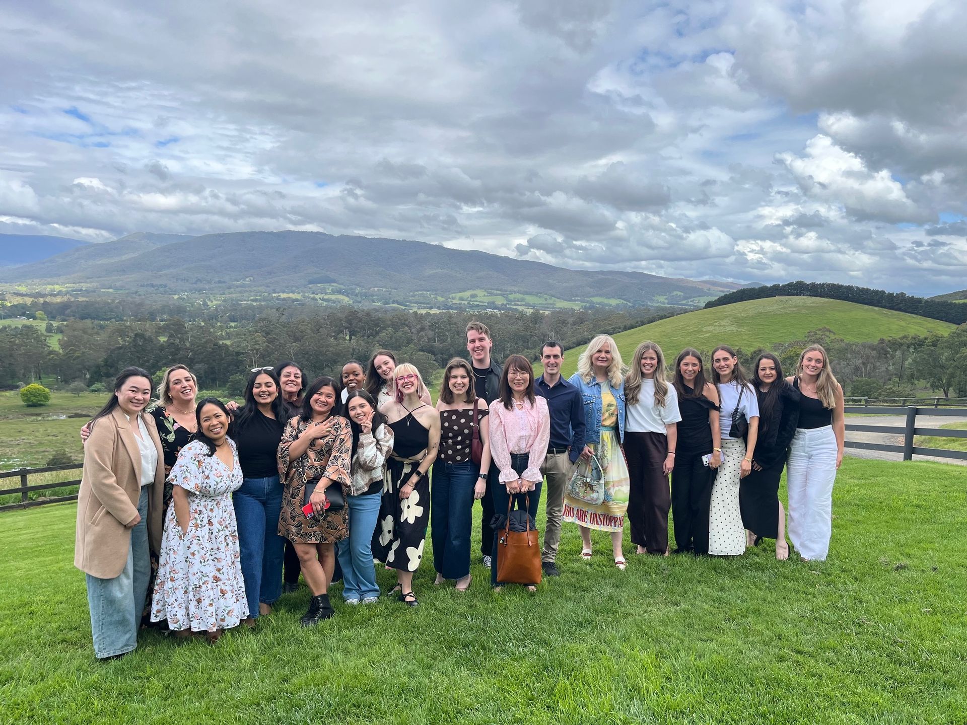 A group of 20 people overlooking the hills of a Yarra Valley winery. These people attended a Ticket 2 Ride winery tour.