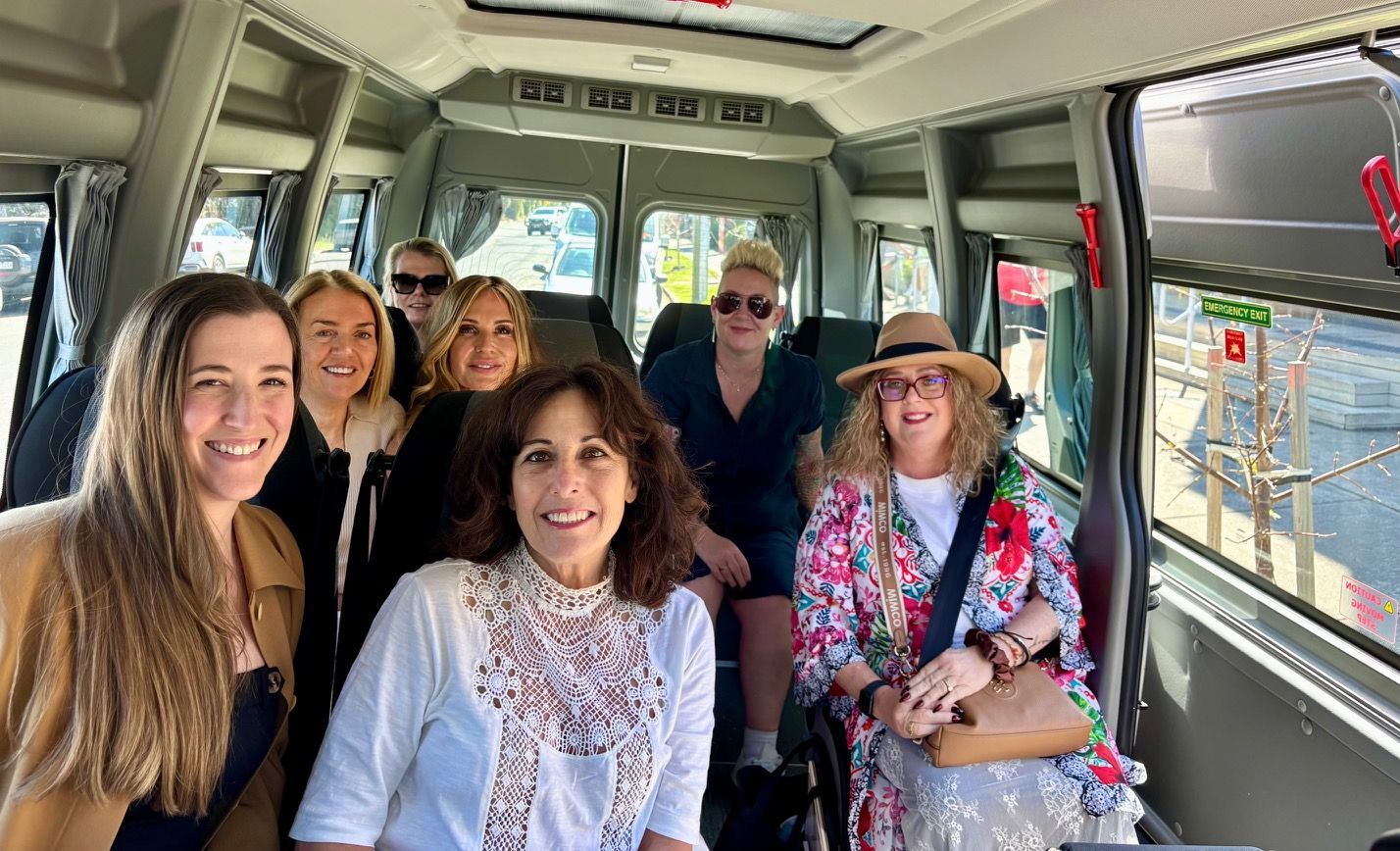 A group in a Ticket 2 Ride minibus, enjoying a winery day trip.