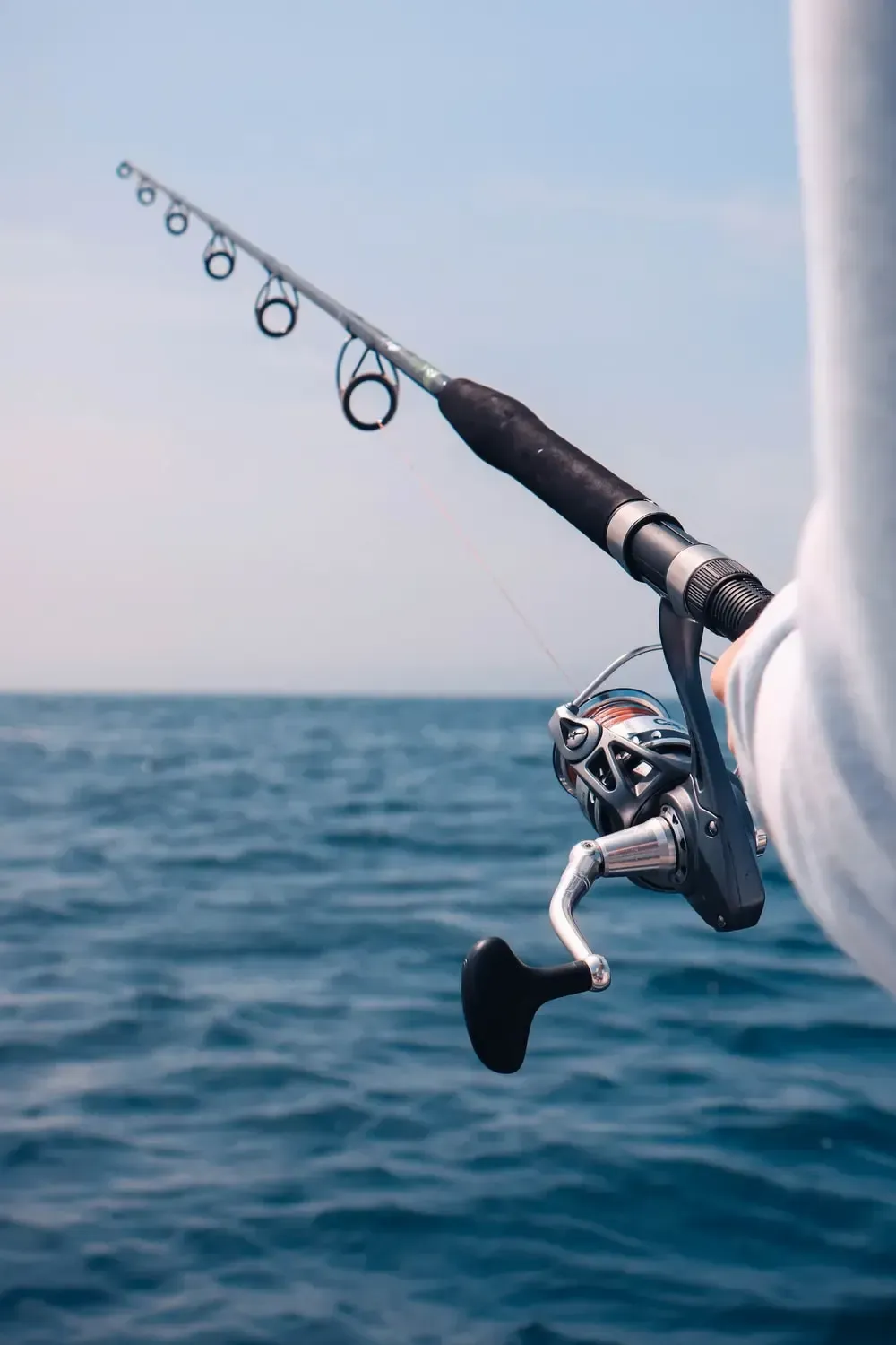 Fishing rod held by angler on deep sea fishing charter Panama City Beach with Reel Groovy