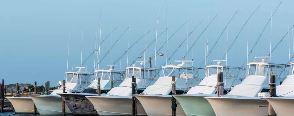 Fishing boats lined up at dock in Panama City Beach for fishing charter tips blog