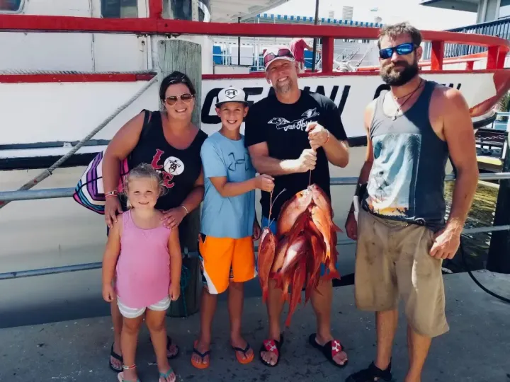 Family with Captain Gary after deep sea fishing charter Panama City Beach with Reel Groovy