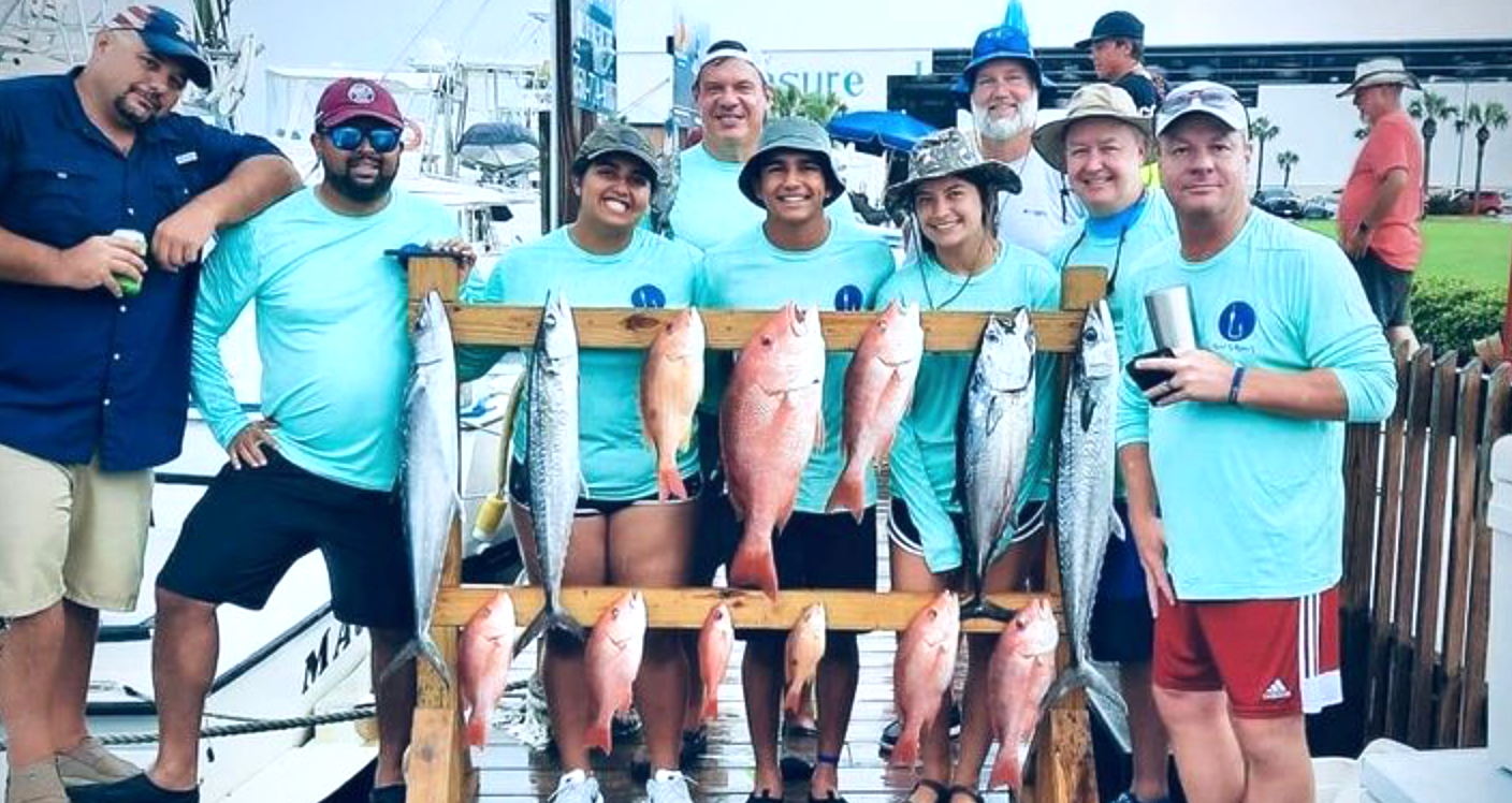 A group of young adults after the best deep sea fishing charter in Panama City Beach, Florida with Reel Groovy Experiences.