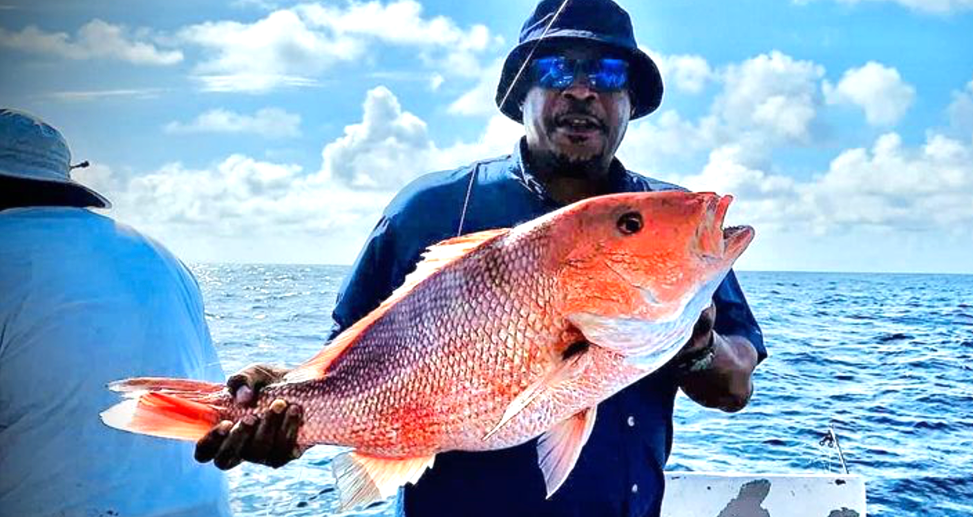 Man holding large red snapper on 8 hour fishing charter Panama City Beach with Reel Groovy Experiences