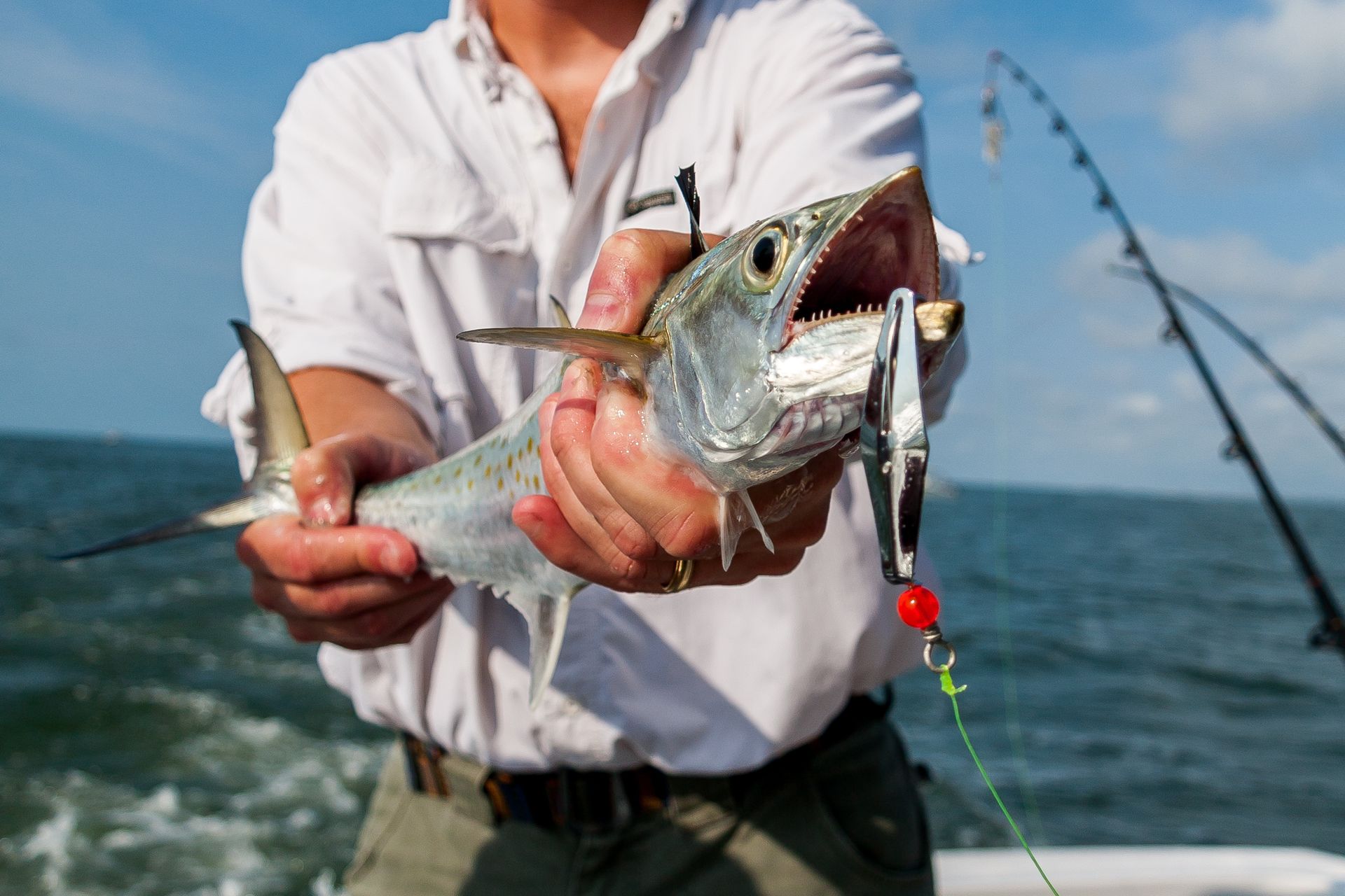 Man holding fish on 8 hour deep sea fishing charter Panama City Beach with Reel Groovy Experiences