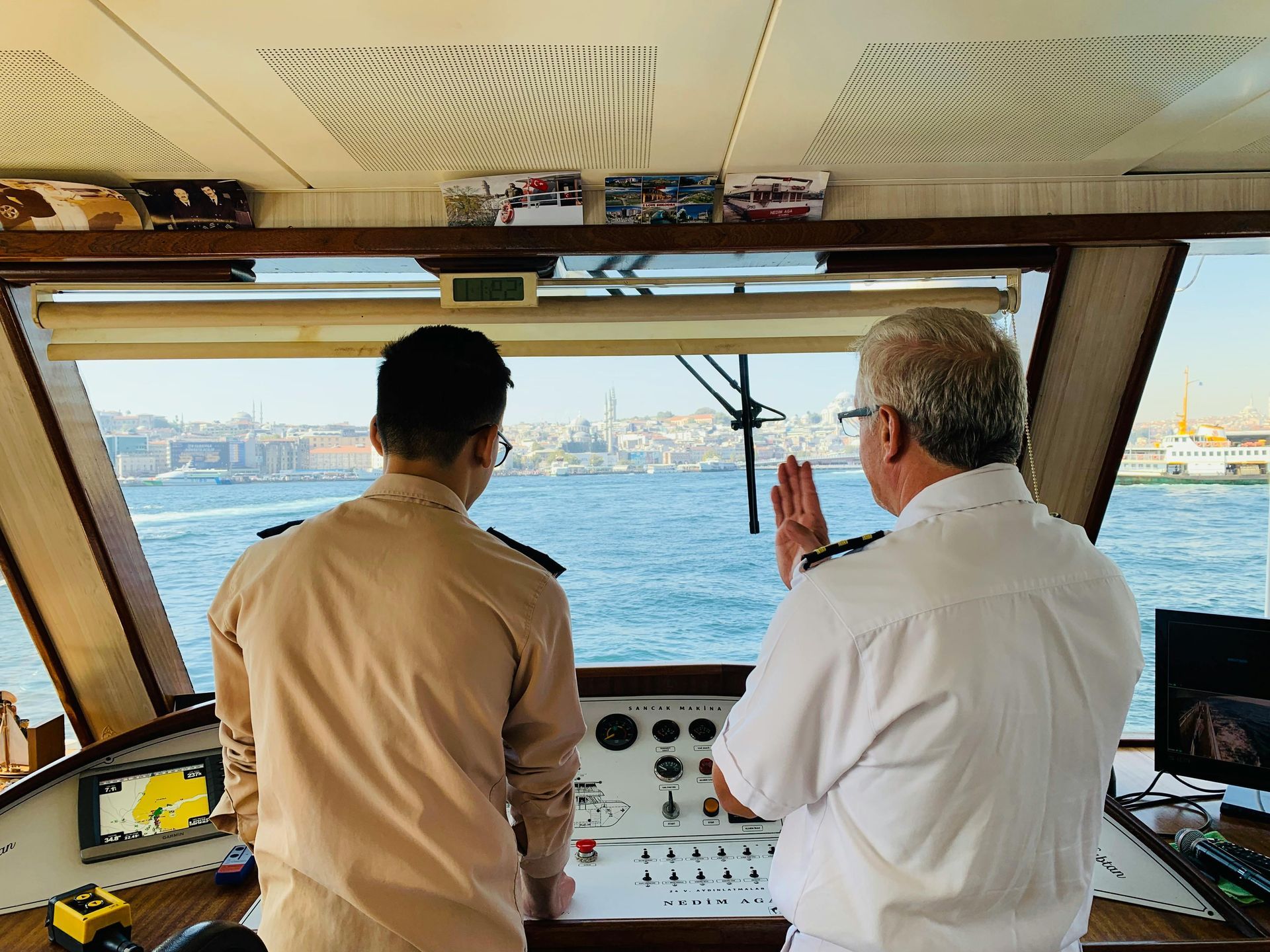 Fishing guide Panama City Beach FL – two fishing guides talking at the helm of a charter boat.