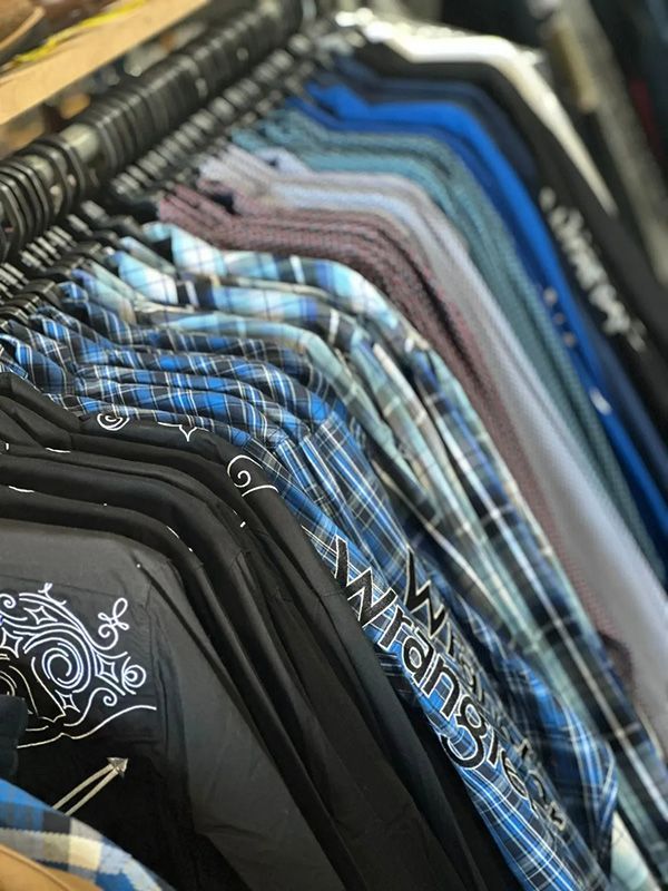 A Row of Wrangler Shirts Are Hanging on A Rack in A Store — Country Charm in Charmhaven, NSW