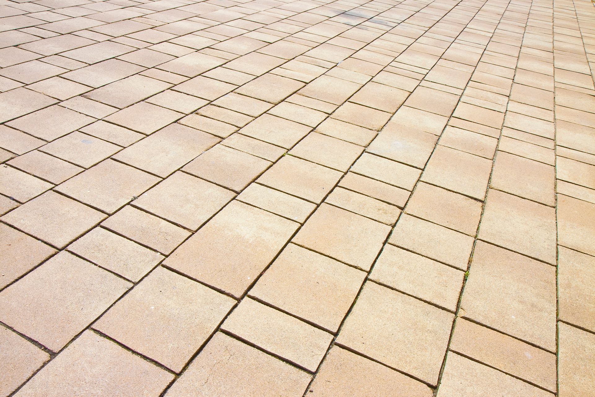 Beige tiled pavement in a repeating diagonal pattern