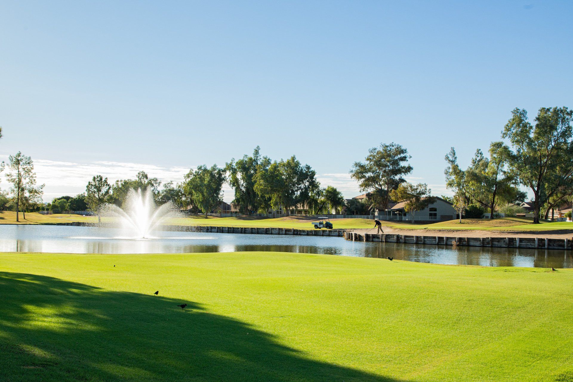 A golf course with a fountain in the middle of it
