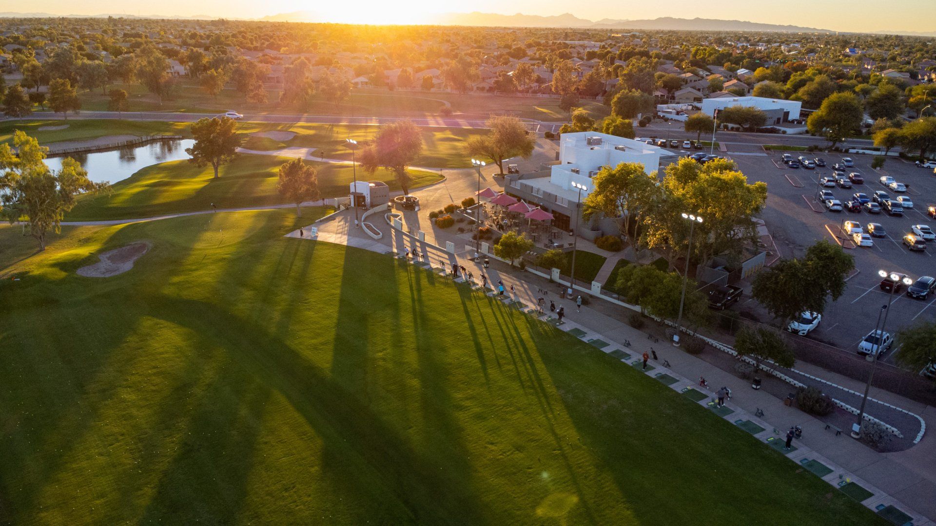 An aerial view of a golf course at sunset.
