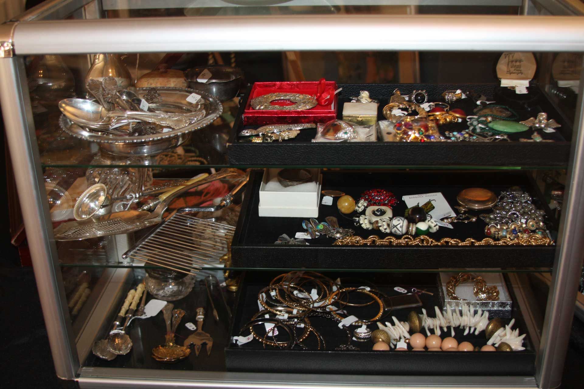 Display case filled with various jewelry and decorative items.