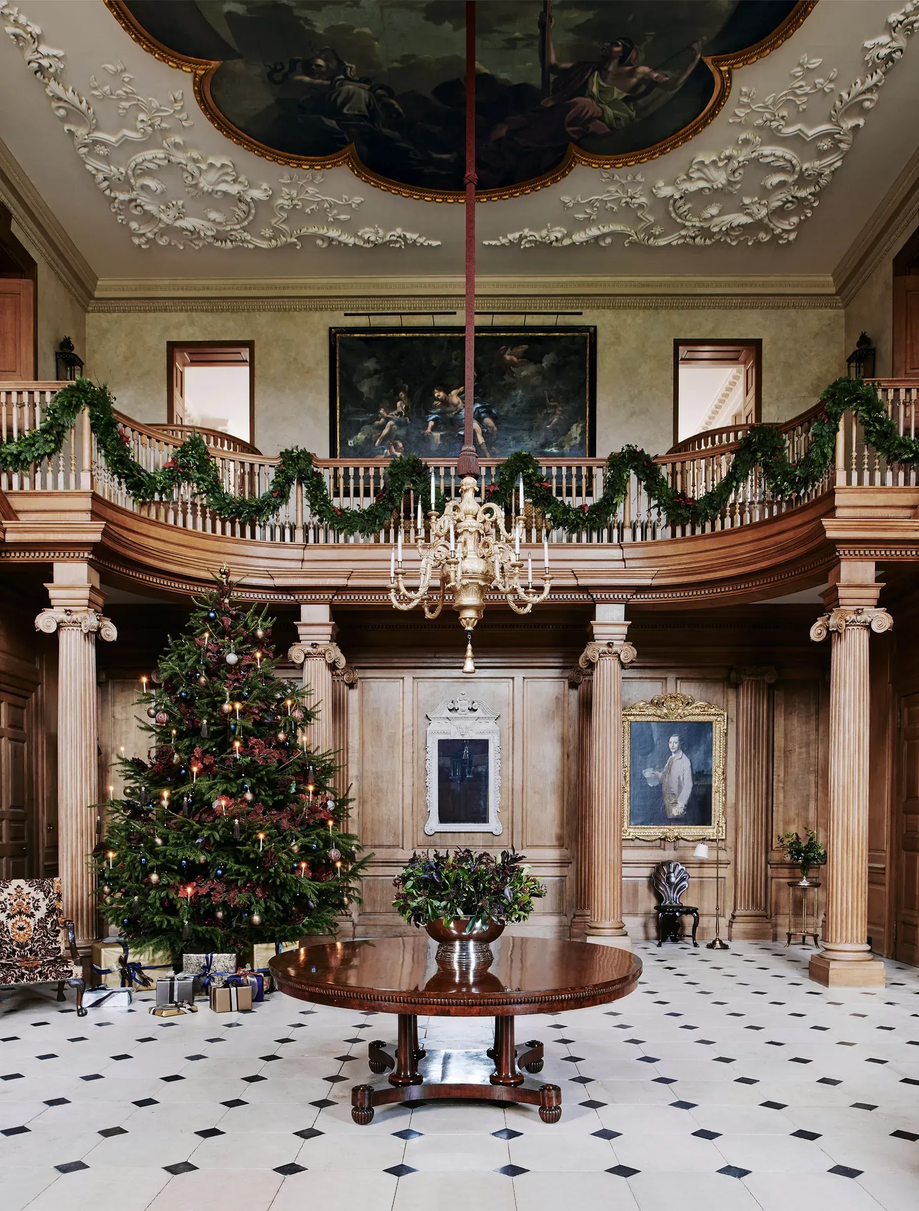 A large room with a christmas tree in the middle A large room with a christmas tree in the middle