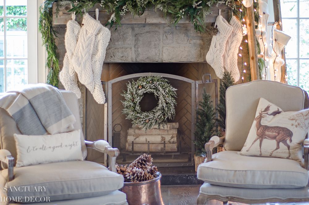 A living room filled with furniture and a fireplace decorated for christmas. A living room filled with furniture and a fireplace decorated for christmas.