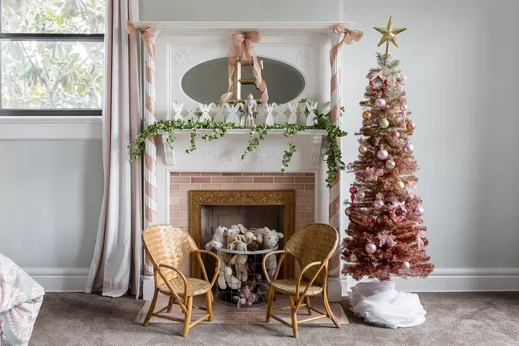 A living room with a fireplace and a pink christmas tree. A living room with a fireplace and a pink christmas tree.