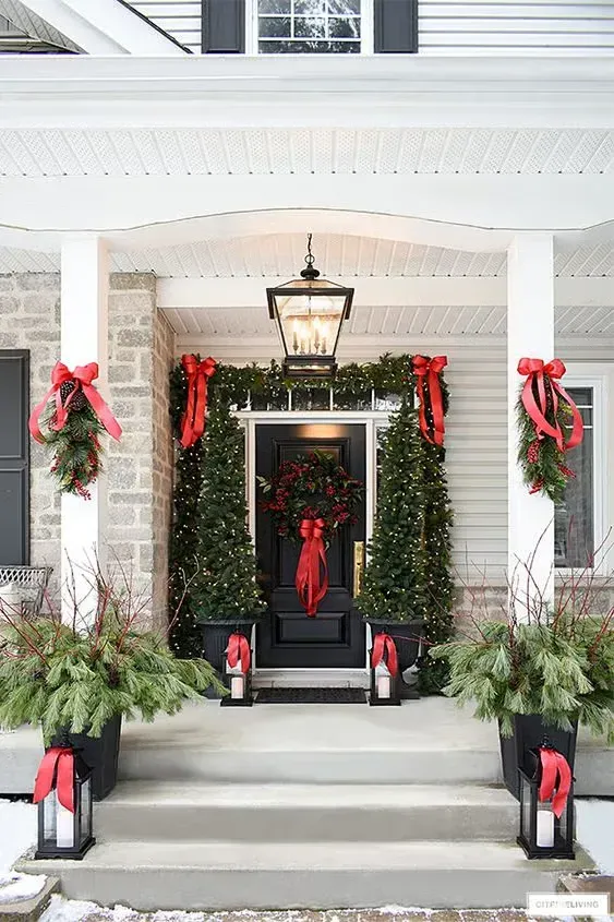 The front porch of a house decorated for christmas with trees and lanterns. The front porch of a house decorated for christmas with trees and lanterns.