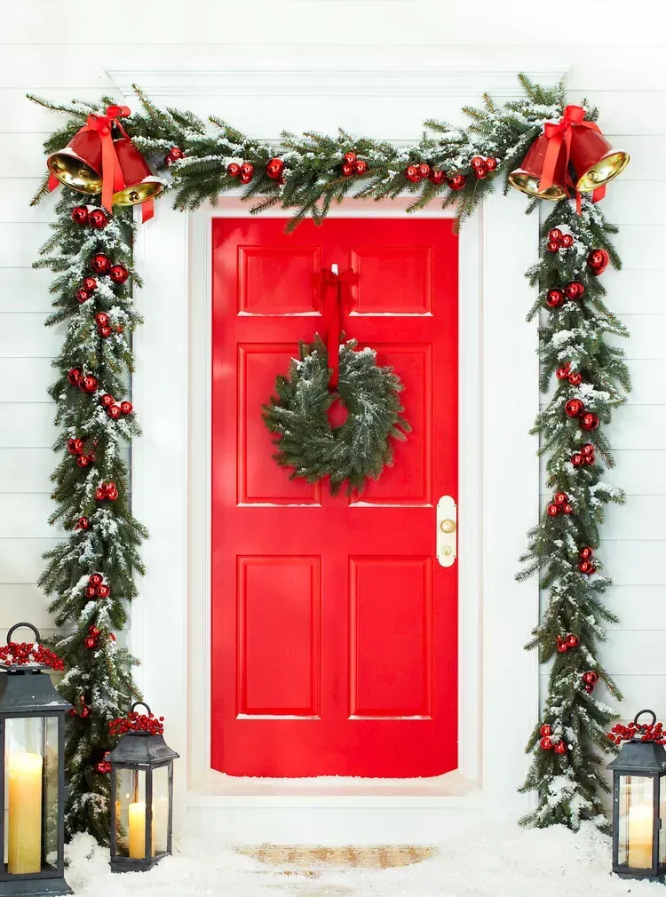 A red door with a christmas wreath on it A red door with a christmas wreath on it