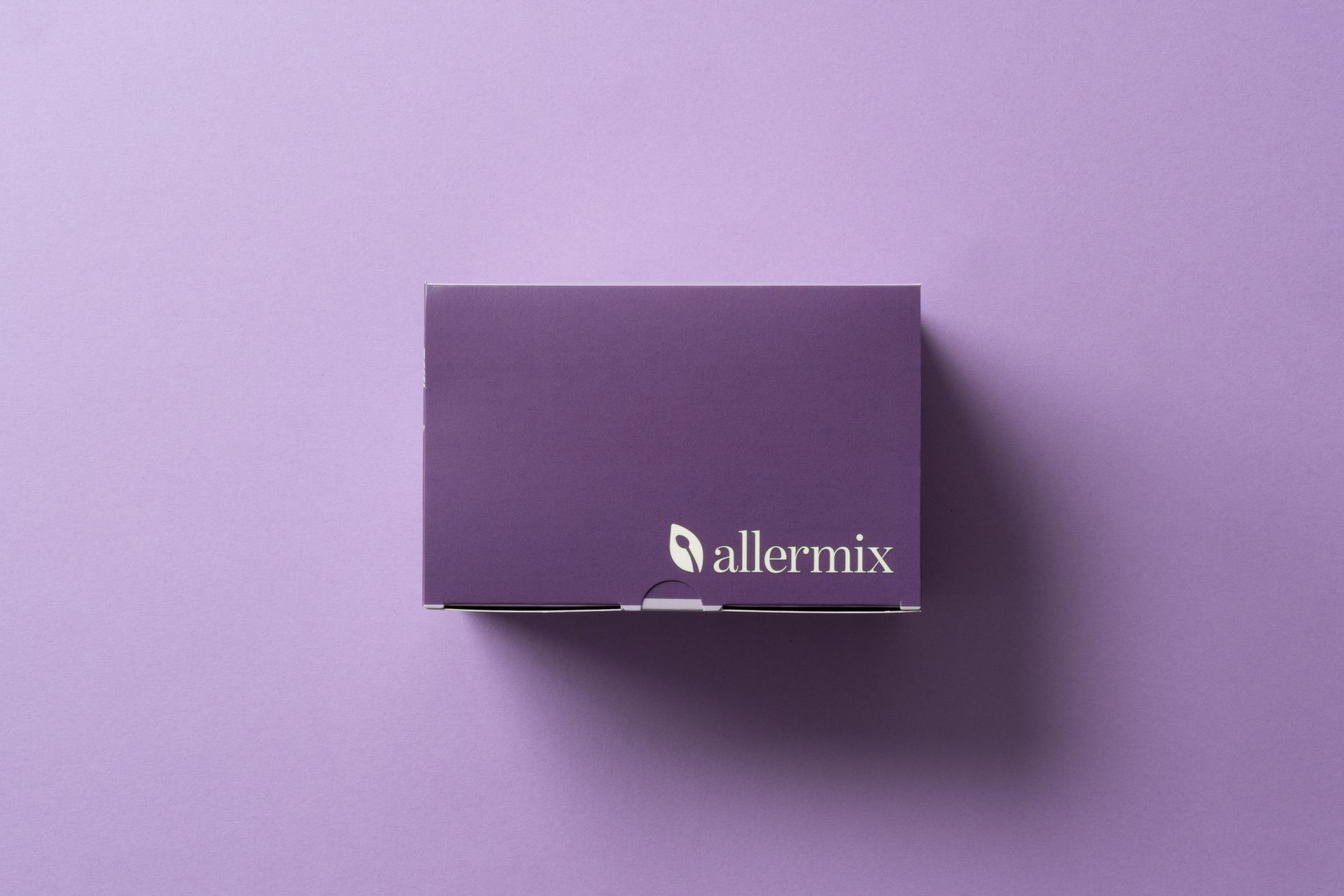 Purple Allermix box on a lavender background with a soft shadow