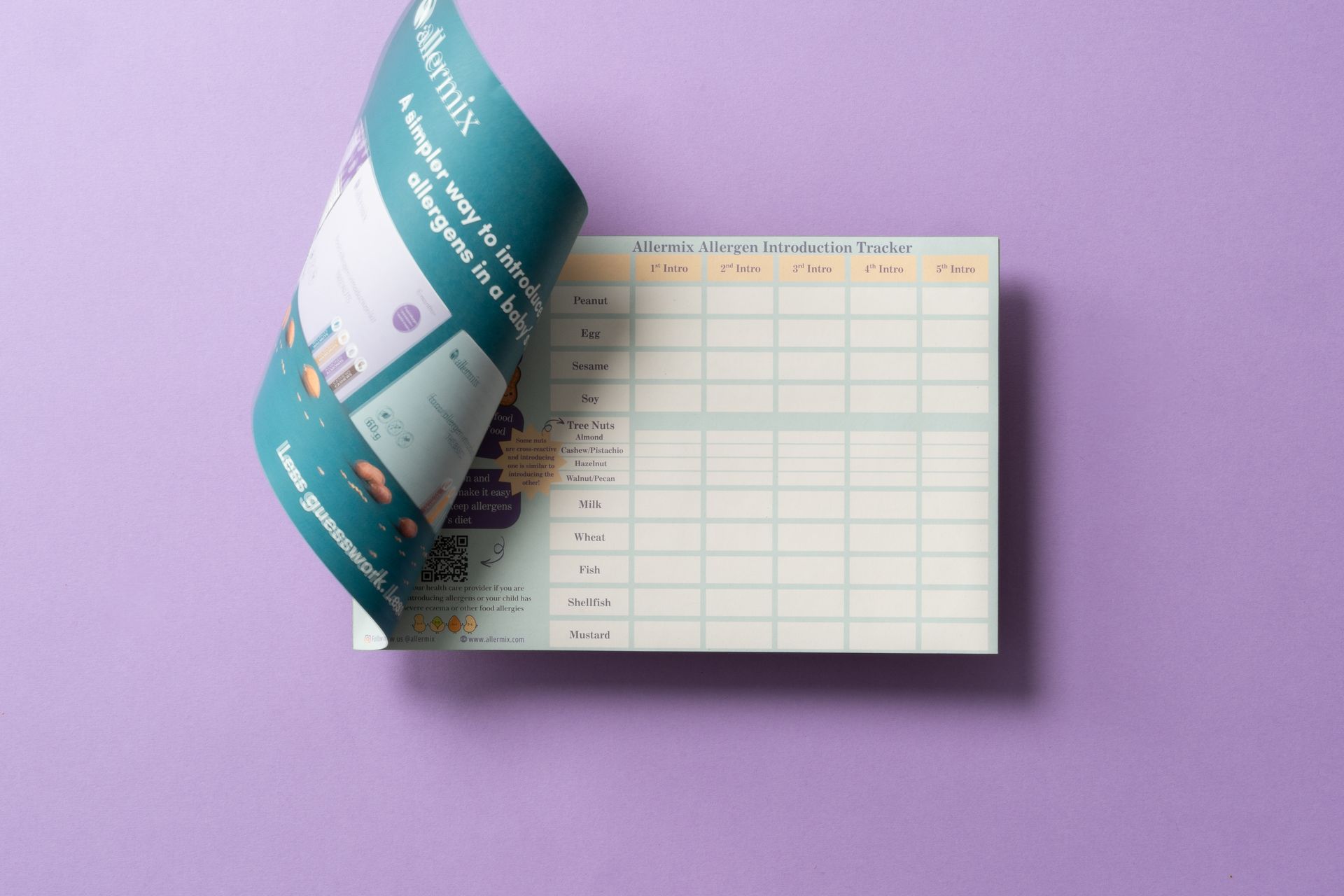 Open planner with a teal page curled over a spreadsheet-style calendar on a purple background